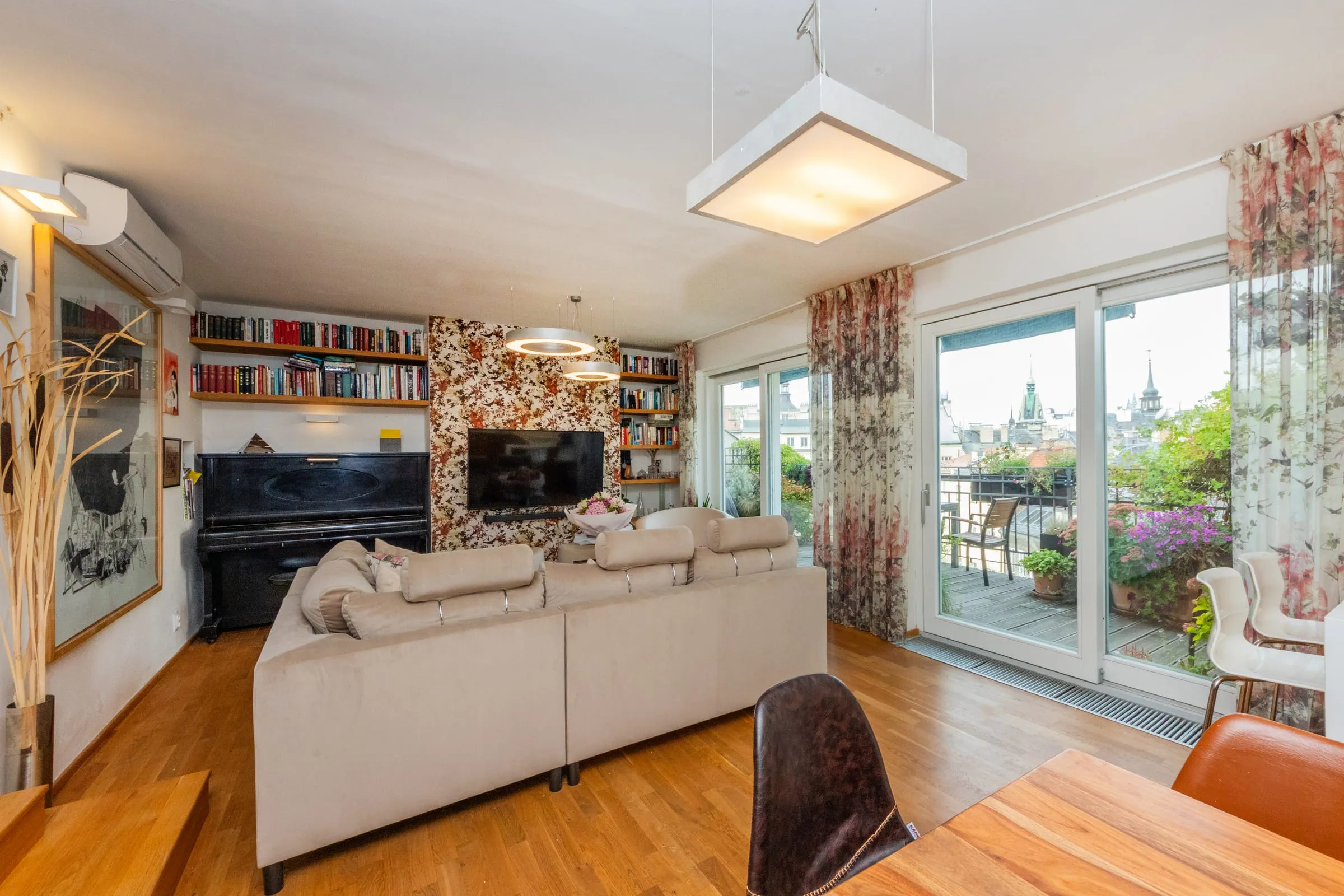 Living room with a piano and glass doors to the terrace